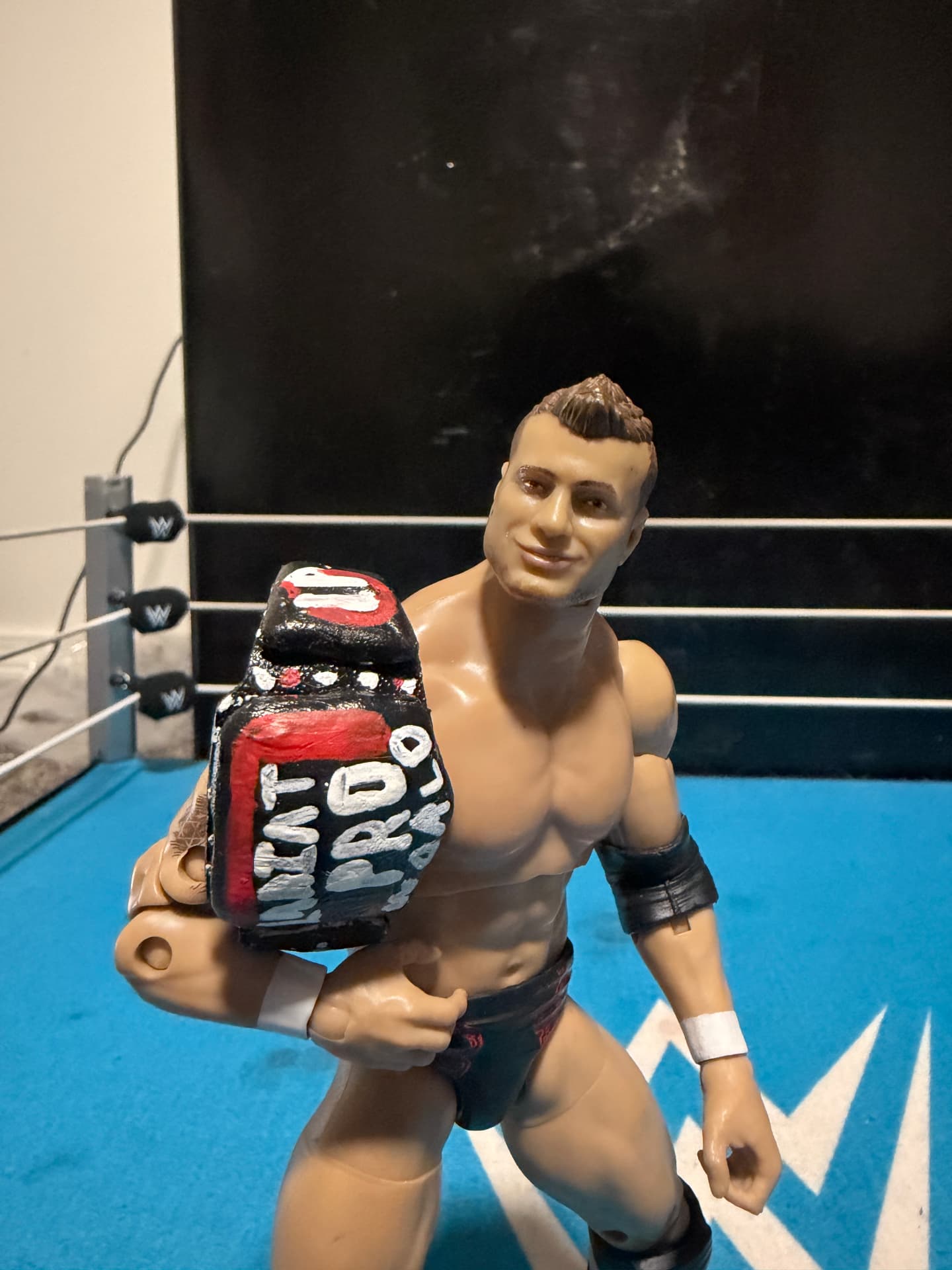 A wrestling figure holding a championship belt