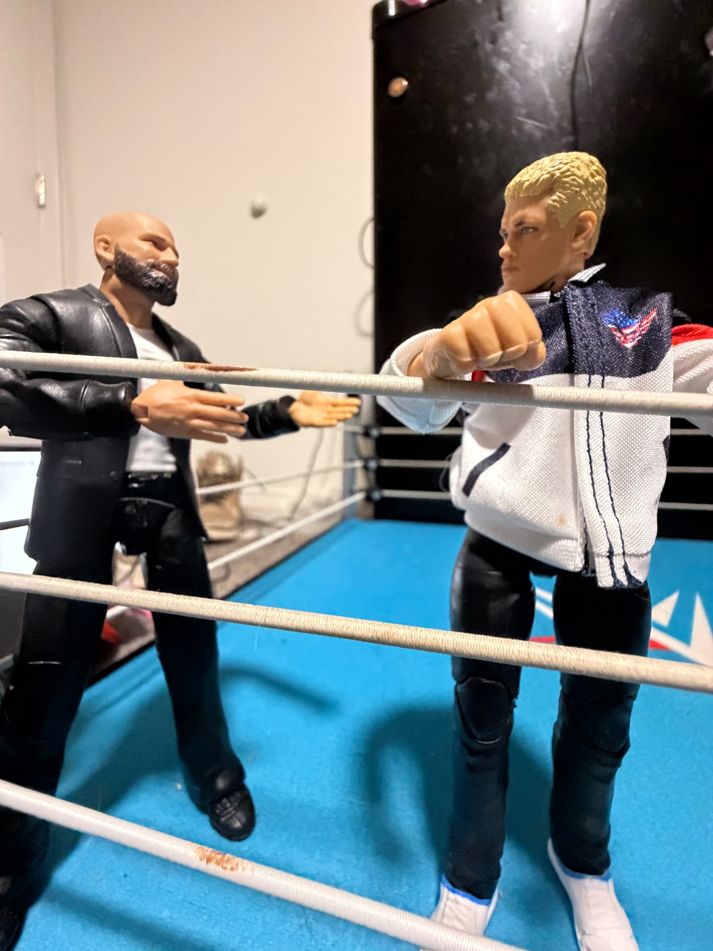 Two suited figures facing each other in the ring