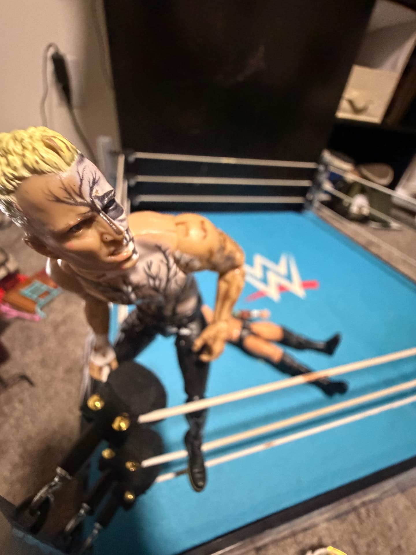 A wrestling figure perched at the ring corner